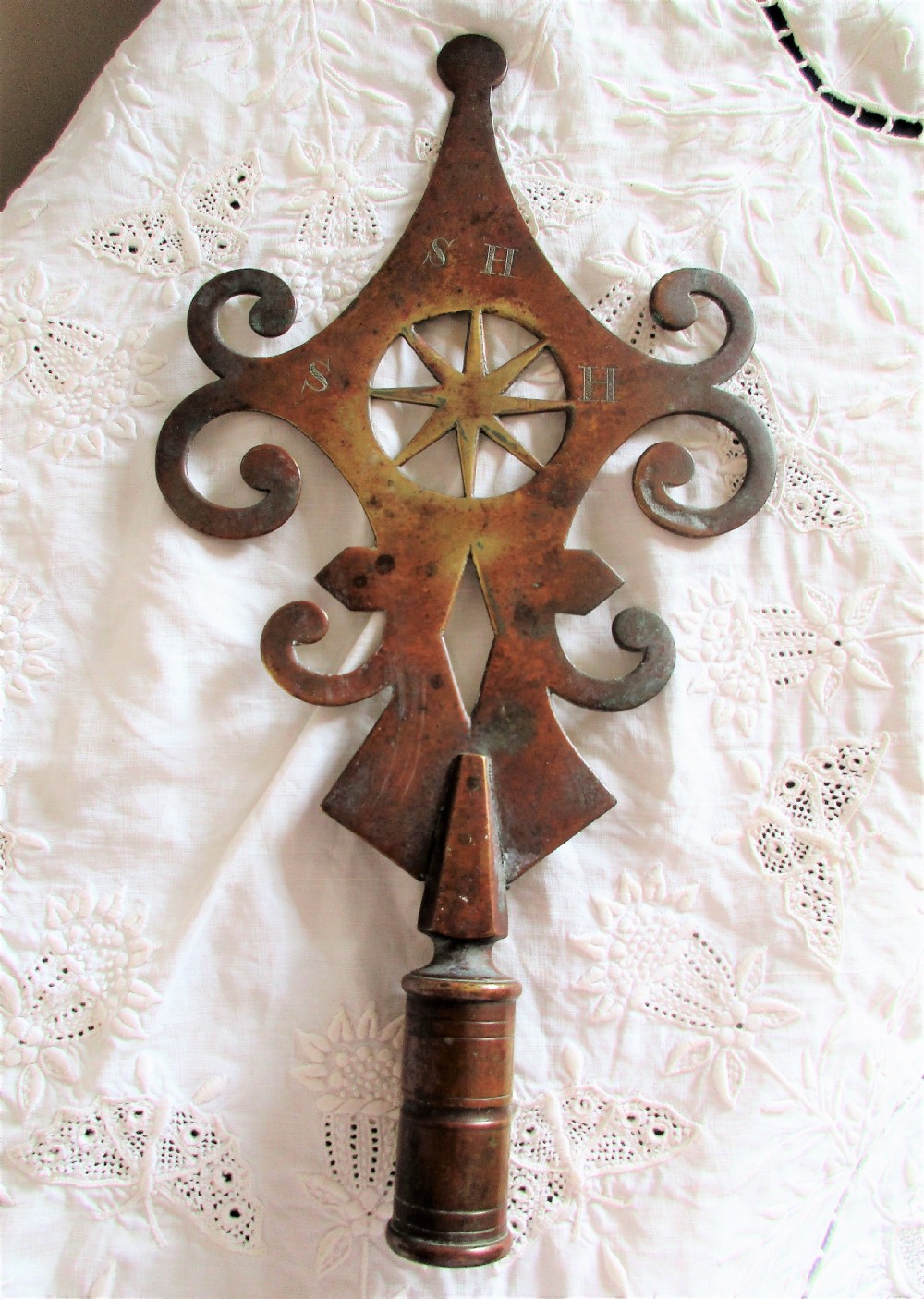 An antique Victorian cast brass friendly society pole head featuring a central star motif within a circular cut-out surrounded by pierced scrollwork and a hollow mounting socket at the base. View II