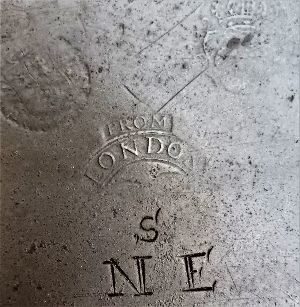 A circular Georgian pewter charger dish featuring a broad flat rim, shallow well, and dark grey patinated metal surface. View III