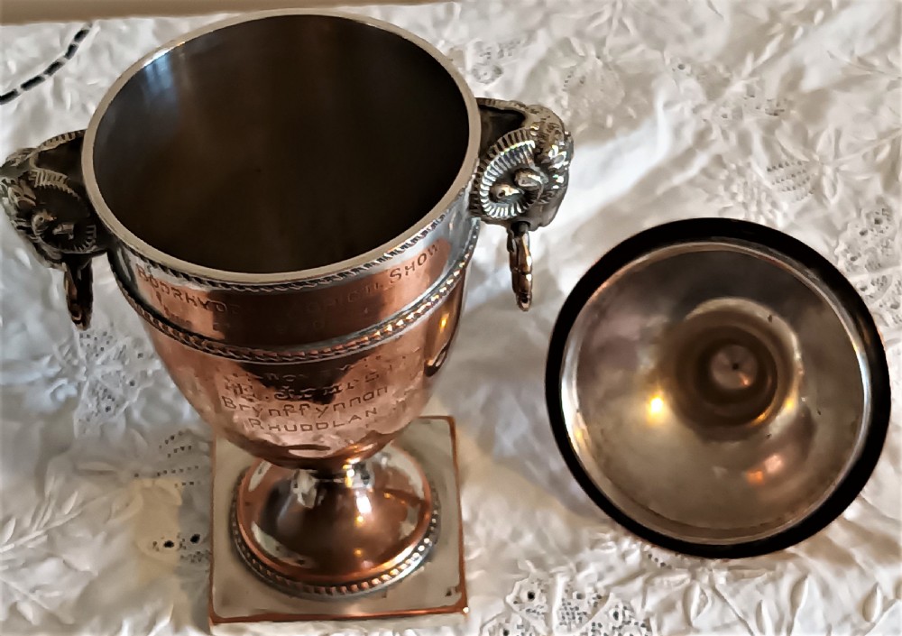 A miniature Georgian Old Sheffield Plate urn featuring a fitted lid with a finial, square base, engraved inscription, and rams head side handles. View VIII