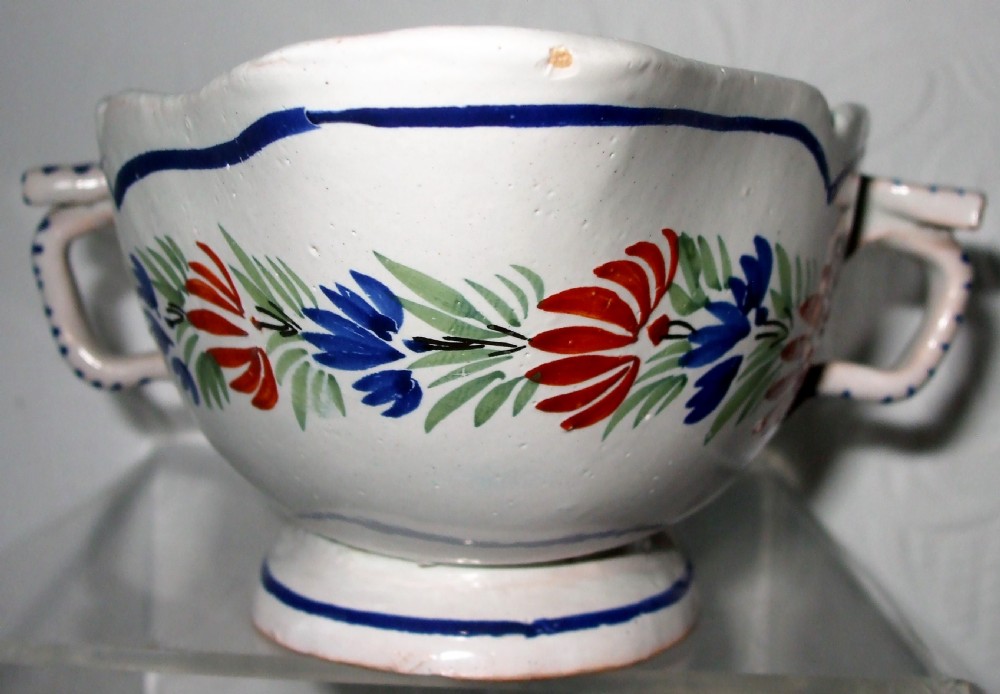 A double-lipped French faience sauceboat featuring hand-painted floral decoration and striped side handles against a white glazed background. View II