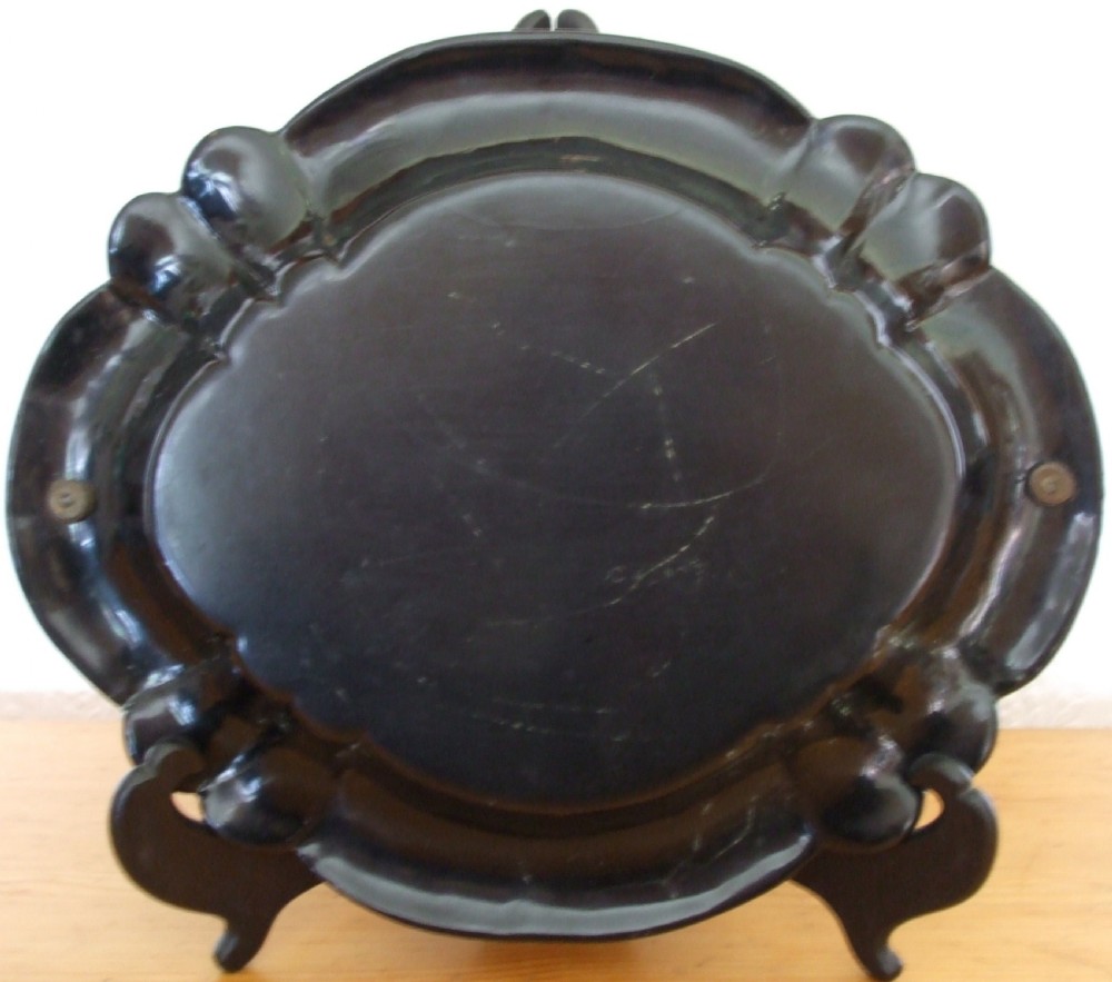 An oval black papier-mache card basket featuring scalloped edges, mother-of-pearl floral inlays, gilding, a painted abbey ruin vignette, and a metal swing handle. View III