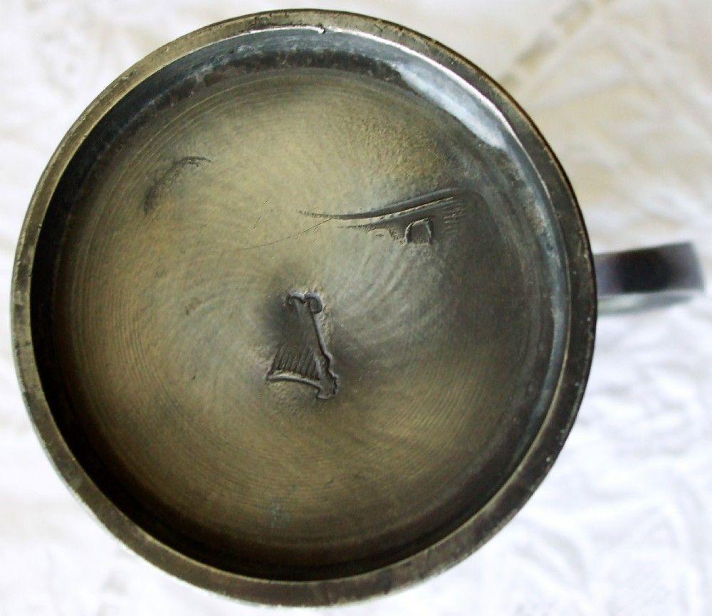 An antique Georgian pewter gill measure featuring a flared rim, incised girdle lines, and a cast curved handle with a dark grey patinated finish. View V