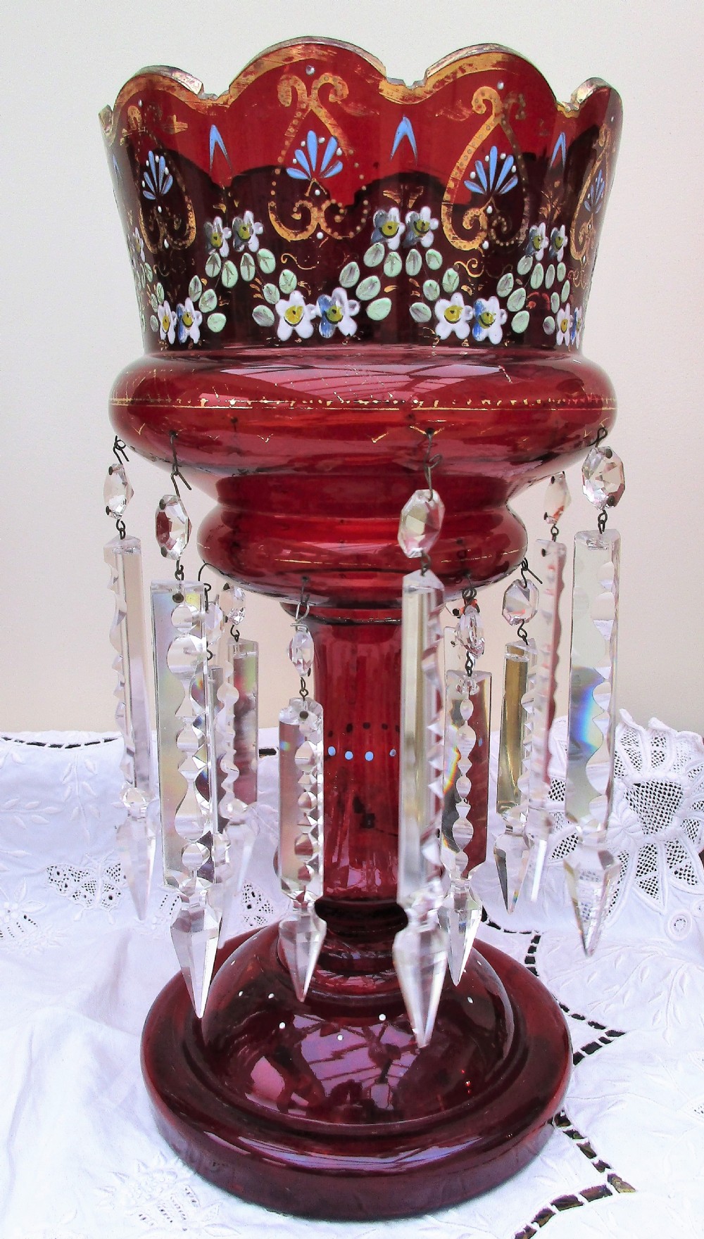 A pair of Victorian ruby red glass lustres featuring hand-painted floral enamel decoration and suspended clear cut-crystal prisms on circular bases. View III
