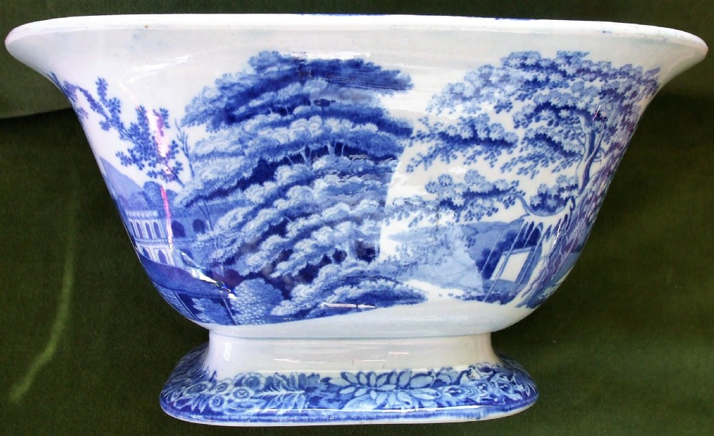 A square antique Georgian blue and white earthenware serving bowl decorated with an Eastern architectural scene and an ornate floral border. View III