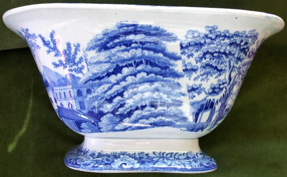 A square antique Georgian blue and white earthenware serving bowl decorated with an Eastern architectural scene and an ornate floral border. View IV