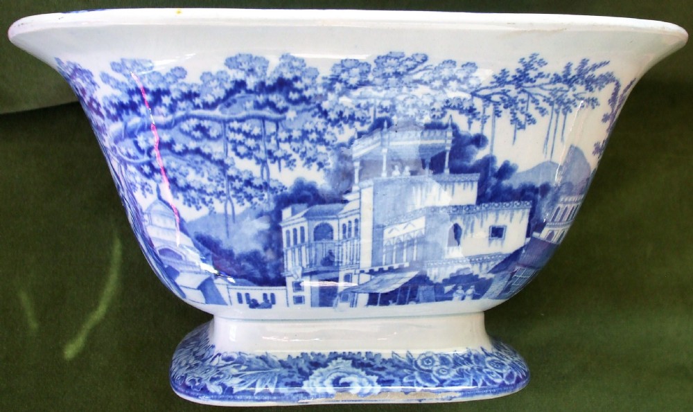 A square antique Georgian blue and white earthenware serving bowl decorated with an Eastern architectural scene and an ornate floral border. View V