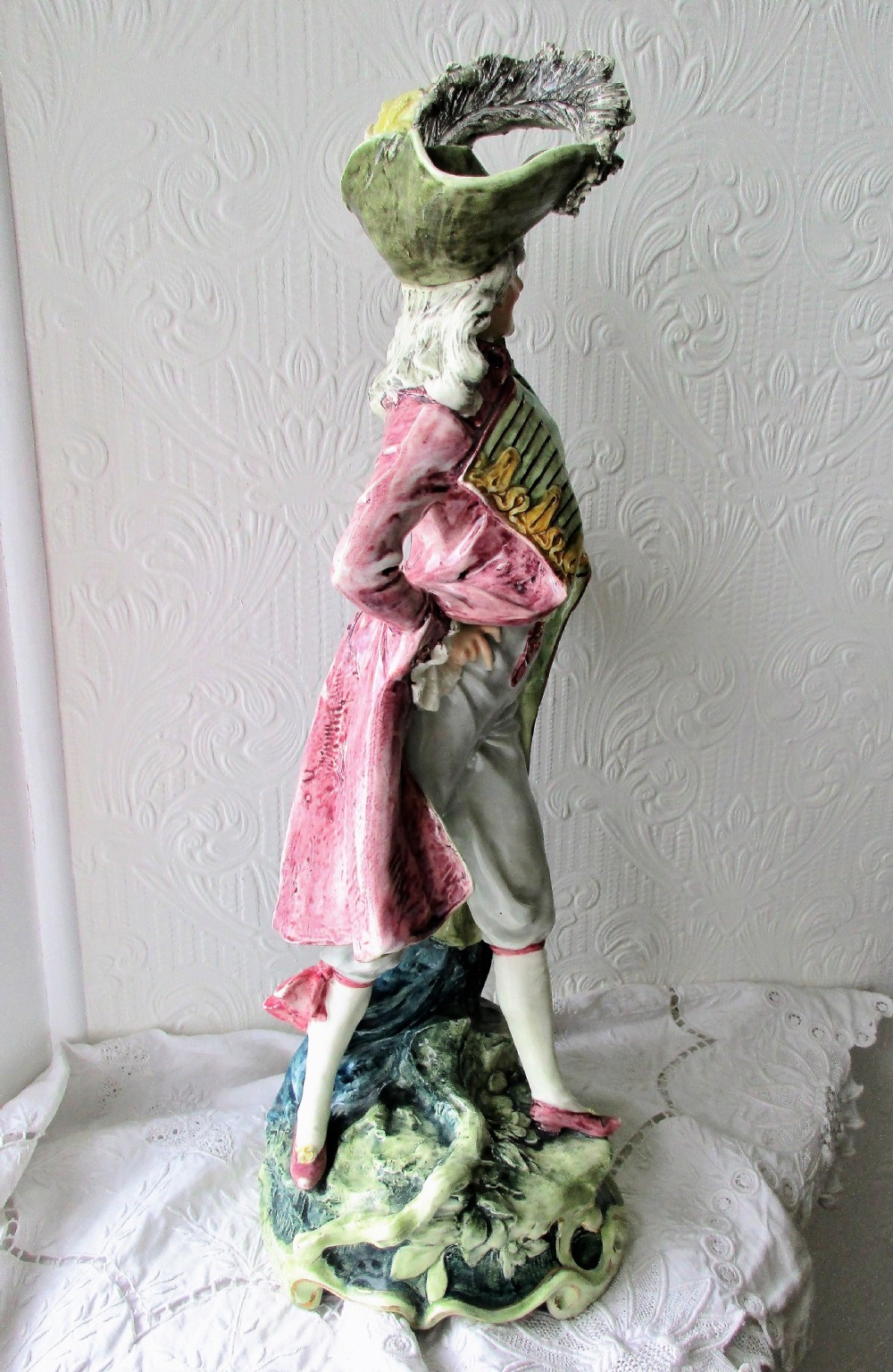 A pair of hand-painted French faience ceramic figurines depicting an 18th-century gentleman and a lady holding a parasol. View VIII