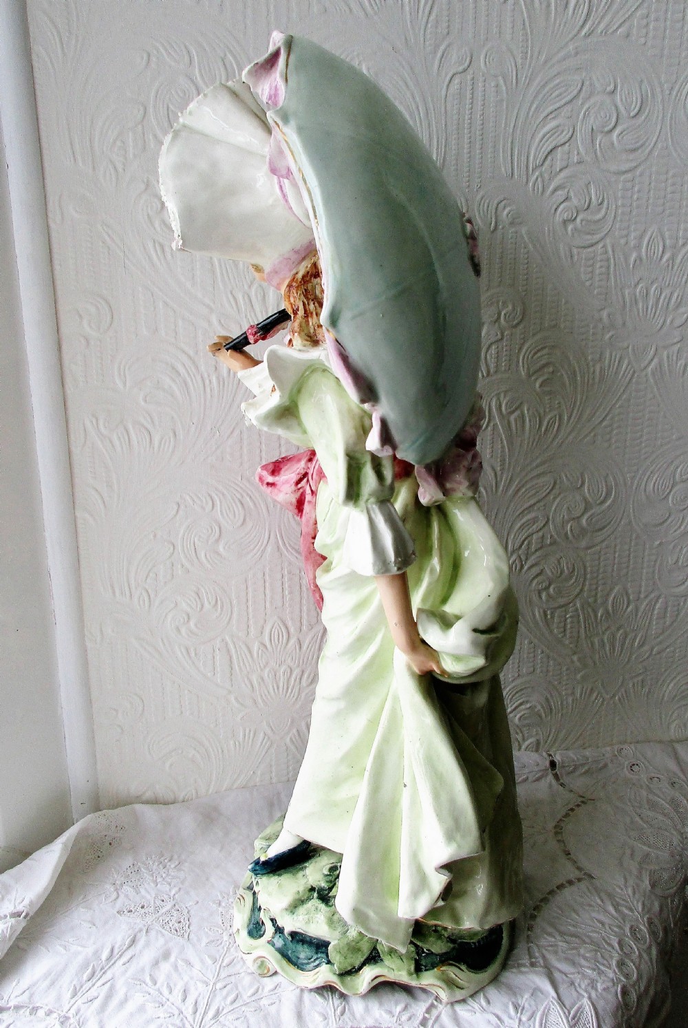 A pair of hand-painted French faience ceramic figurines depicting an 18th-century gentleman and a lady holding a parasol. View XI