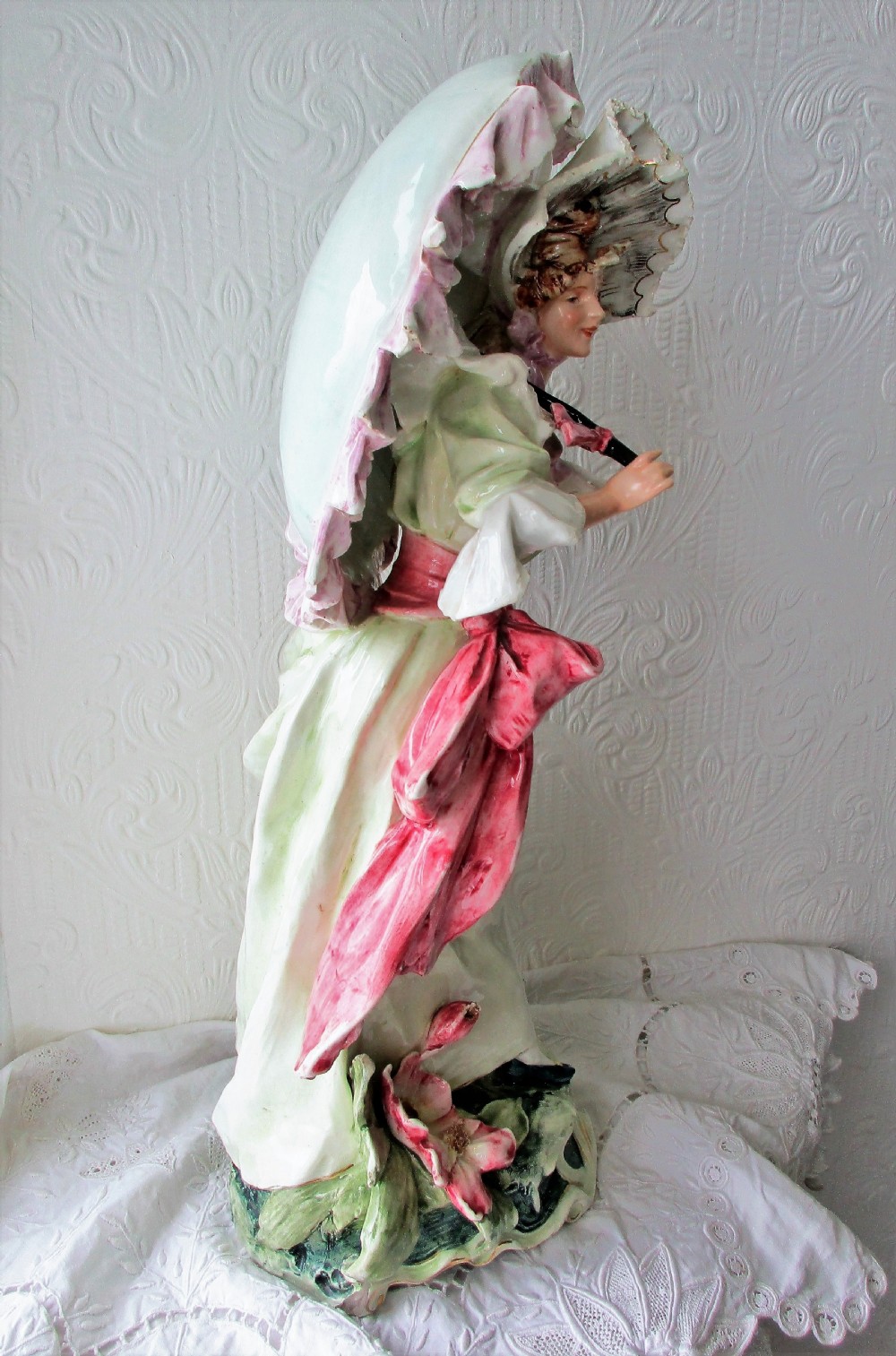 A pair of hand-painted French faience ceramic figurines depicting an 18th-century gentleman and a lady holding a parasol. View XIII