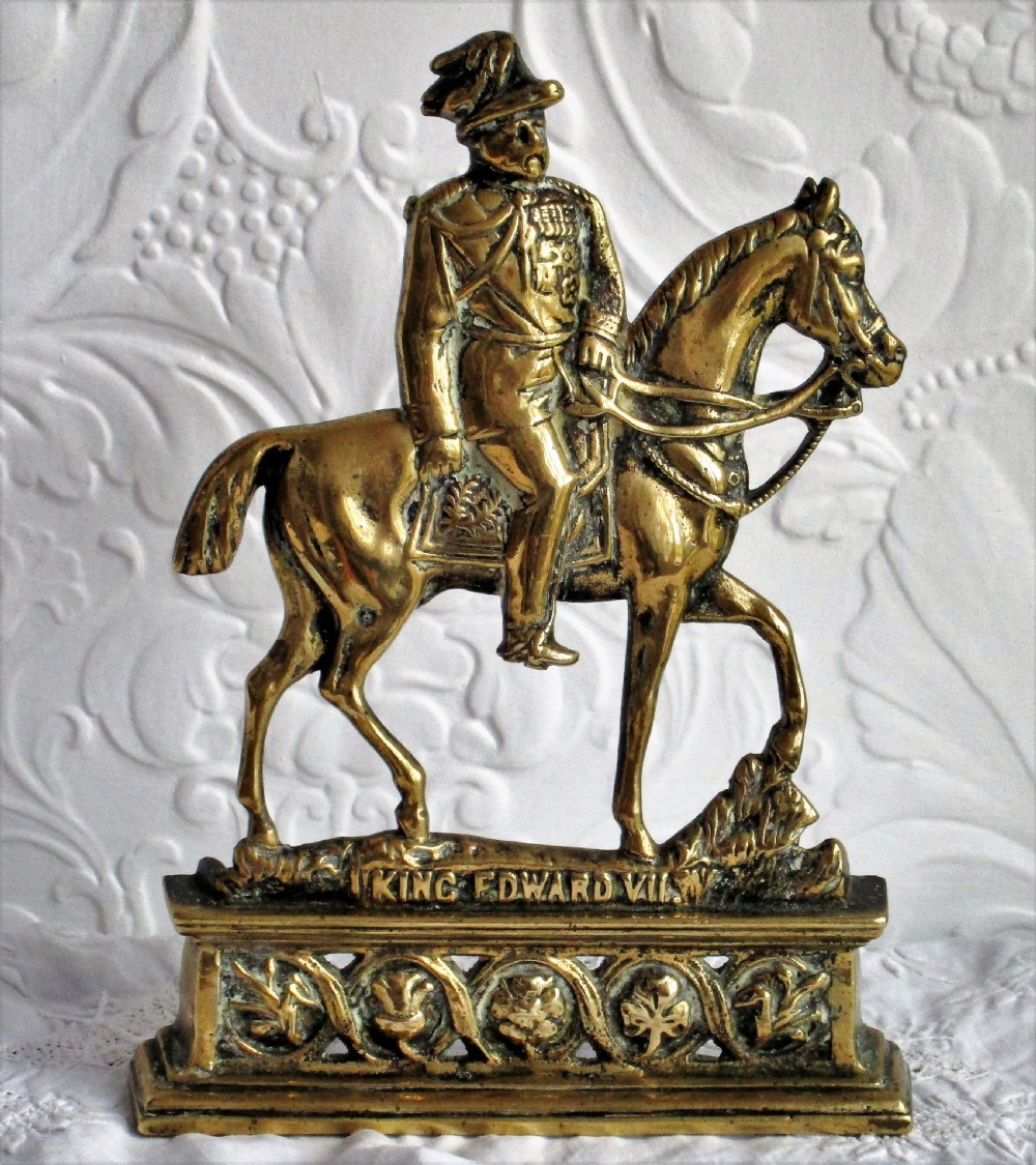 A pair of antique cast brass equestrian figures depicting King Edward VII and Queen Alexandra set on decorative plinth bases. View II