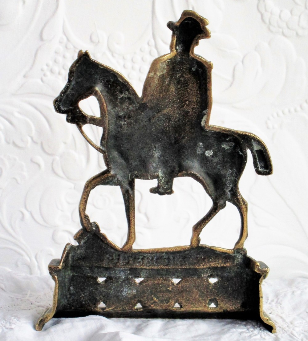 A pair of antique cast brass equestrian figures depicting King Edward VII and Queen Alexandra set on decorative plinth bases. View III