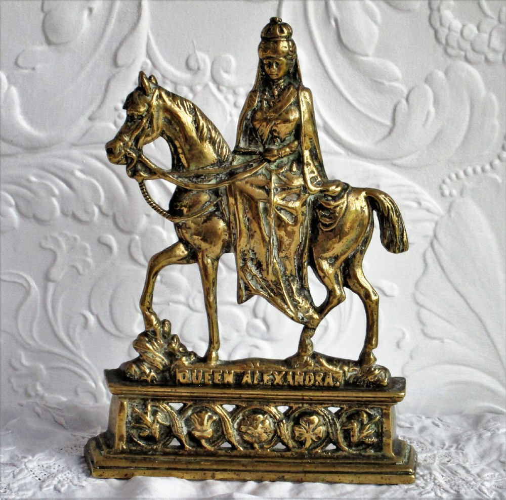 A pair of antique cast brass equestrian figures depicting King Edward VII and Queen Alexandra set on decorative plinth bases. View IV