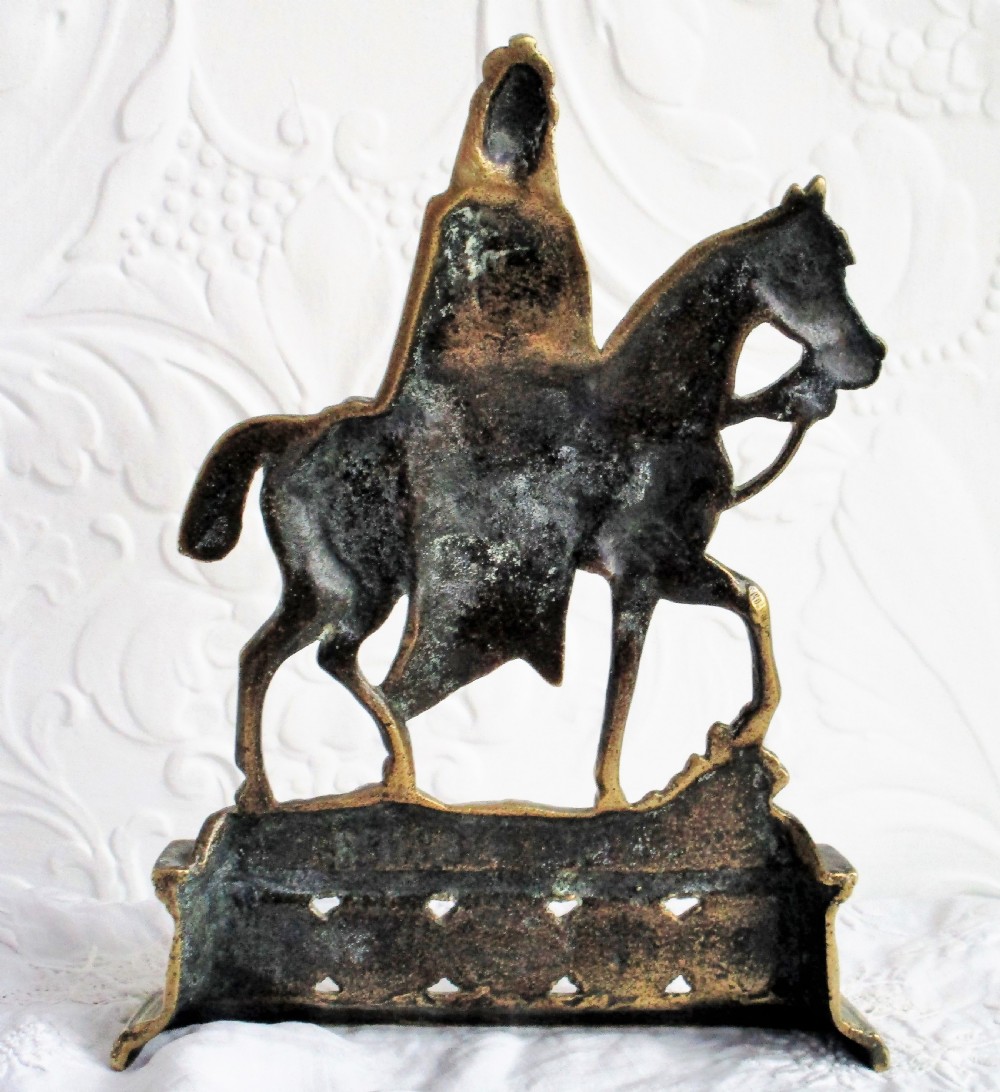 A pair of antique cast brass equestrian figures depicting King Edward VII and Queen Alexandra set on decorative plinth bases. View V