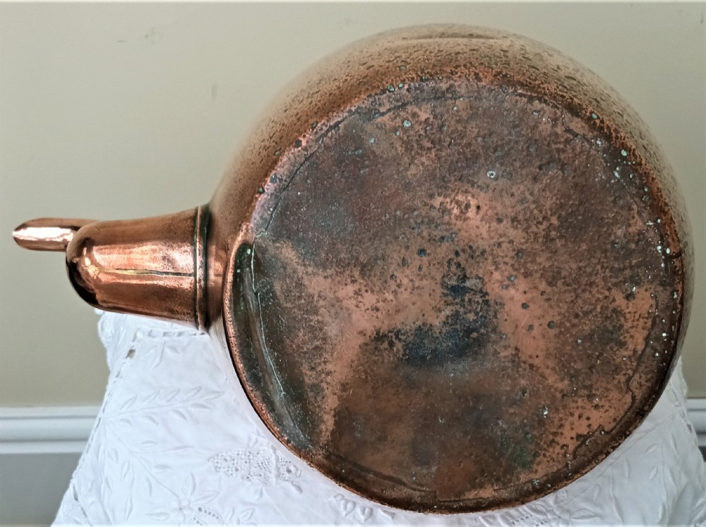 An antique Victorian copper kettle featuring a gooseneck spout, a fixed overhead loop handle, and a domed lid topped with a brass finial. View VI