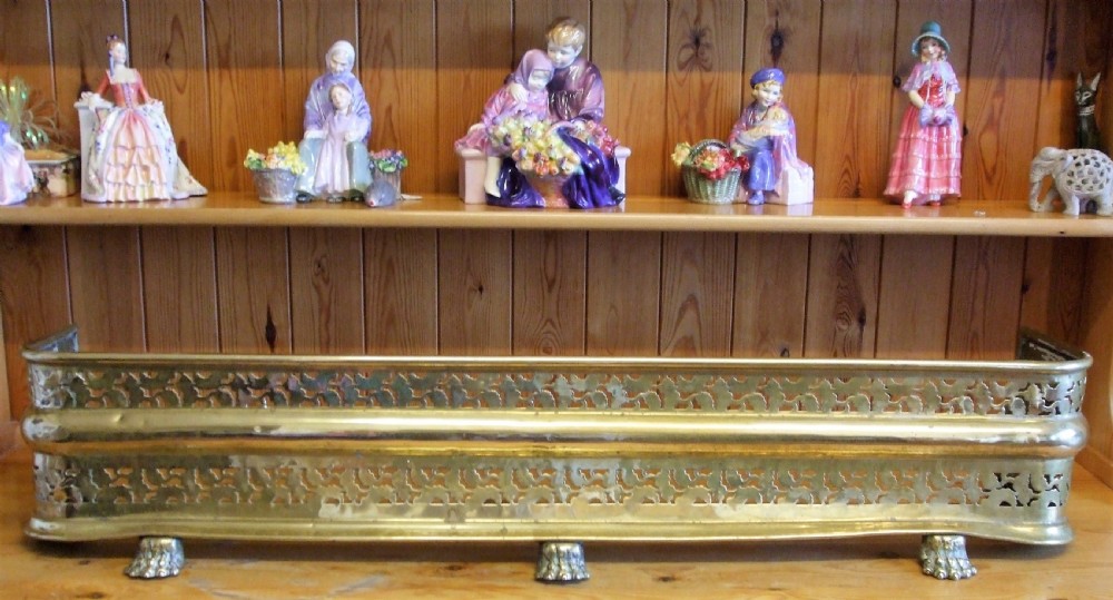 A Victorian pierced brass fireplace fender with central rope-twist moulding, pierced fretwork bands, and cast paw feet. View XV