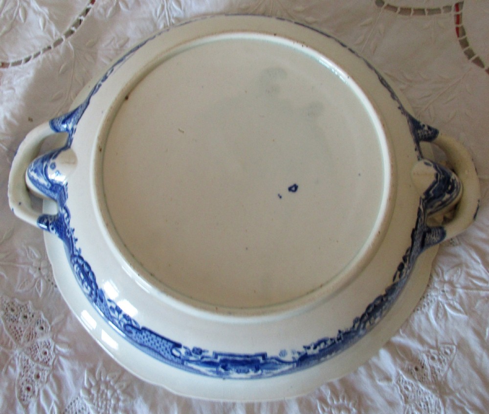 An antique Georgian circular blue and white transferware hot-water plate with side handles featuring a central Gothic castle scene and ornate border. View III