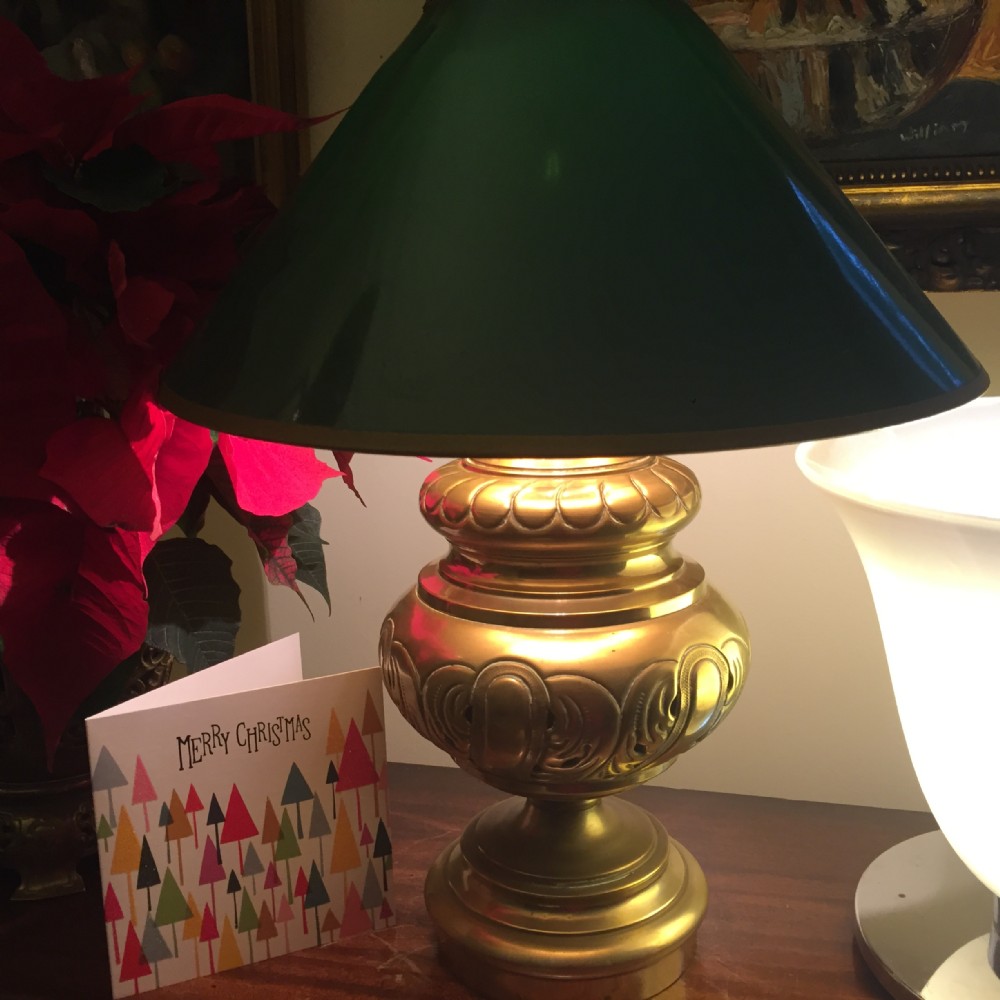 A 19th-century French converted brass oil lamp featuring a repousse decorated base and a dark green conical shade.