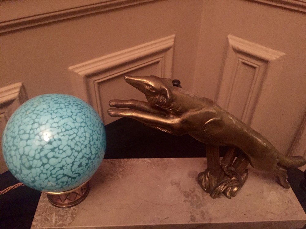 An Art Deco night light featuring a cast bronze leaping greyhound beside a frosted glass globe shade mounted on a rectangular cream marble base. View VI