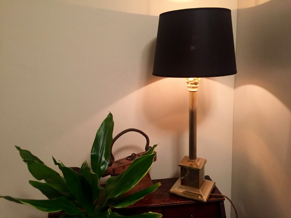 An Edwardian brass desk lamp featuring a fluted column stem on a stepped square plinth base, fitted with a black drum lampshade. View IV