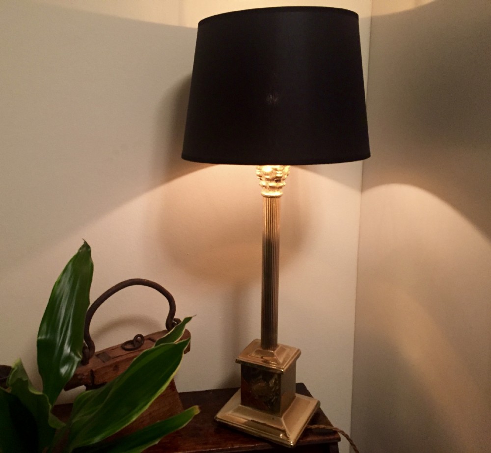An Edwardian brass desk lamp featuring a fluted column stem on a stepped square plinth base, fitted with a black drum lampshade. View VI