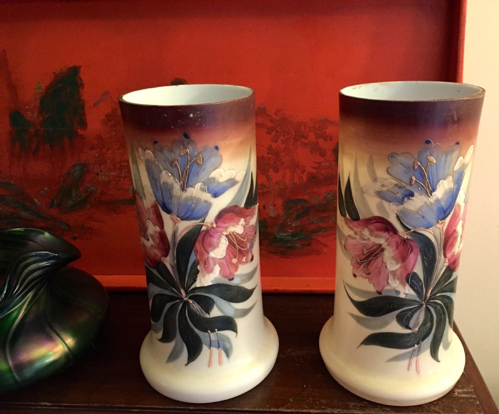 A pair of cylindrical Art Nouveau opaline glass vases with flared bases, decorated with hand-painted blue and pink floral enamel designs and dark gradient rims. View IV