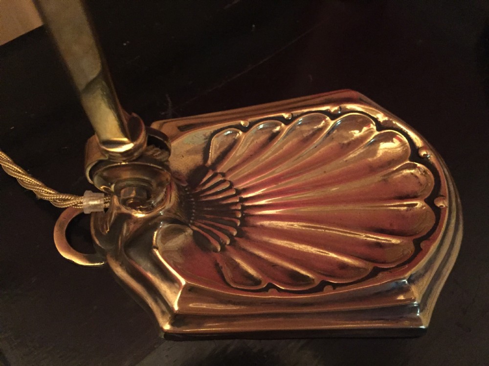 An adjustable Edwardian brass desk lamp with a shell-shaped cast base, curved stem, and a frosted glass shade. View IX