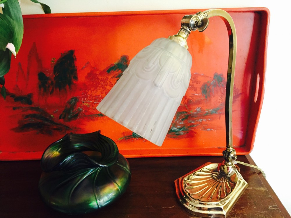 An adjustable Edwardian brass desk lamp with a shell-shaped cast base, curved stem, and a frosted glass shade. View XI