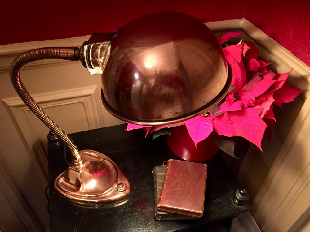 An Edwardian copper desk lamp featuring a hemispherical dome shade, a flexible gooseneck arm, and a molded base with an integrated switch. View V
