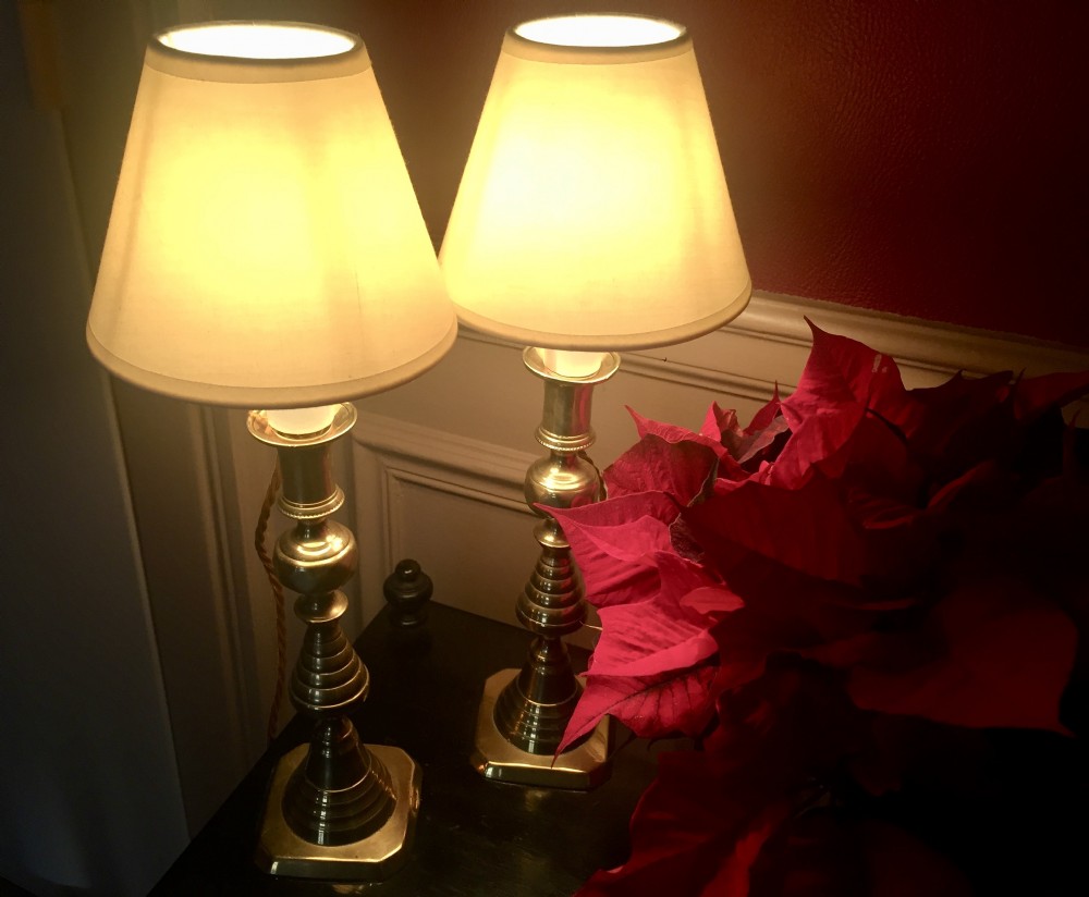 A pair of turned brass table lamps designed in the style of Georgian candlesticks with stepped square bases. View VI