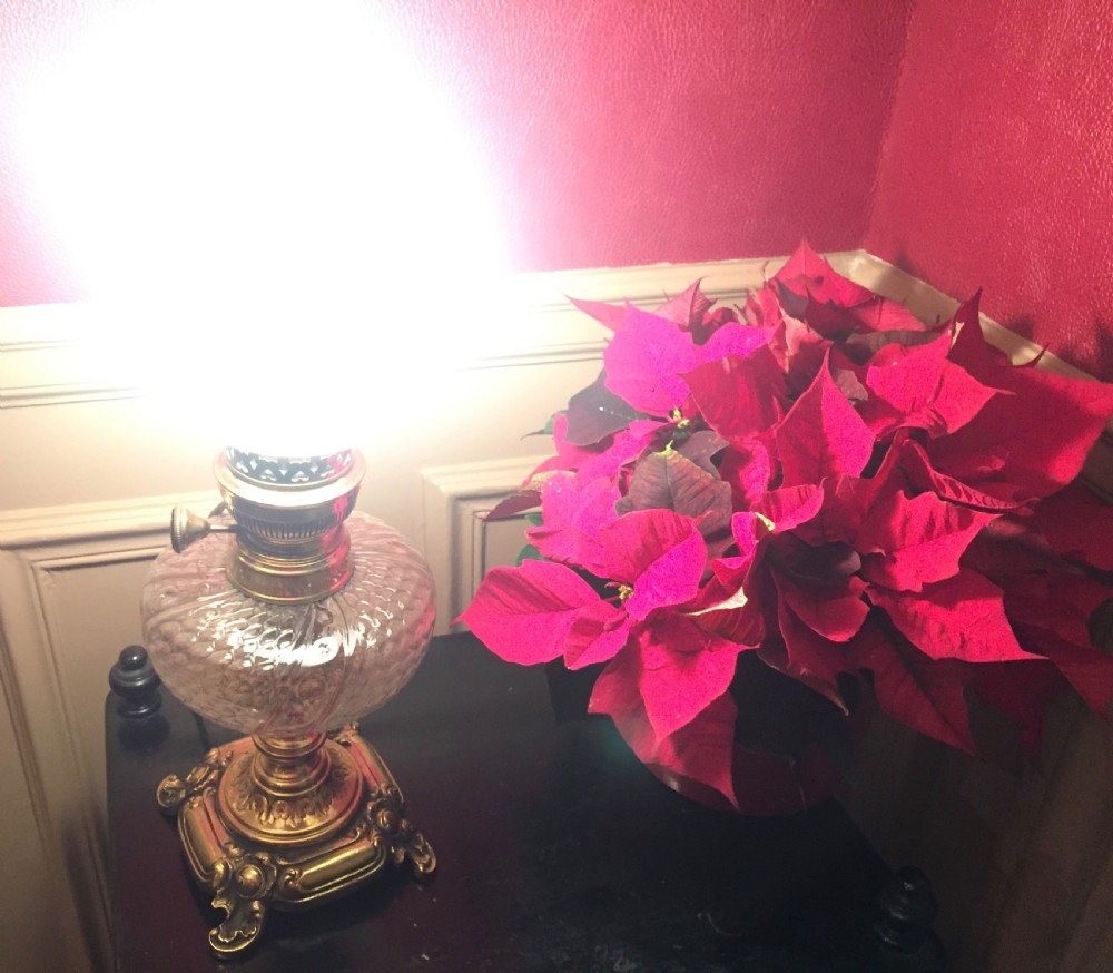 An Art Nouveau table lamp featuring an ornate cast brass base, a clear patterned glass reservoir, and a frosted spherical glass shade. View VIII