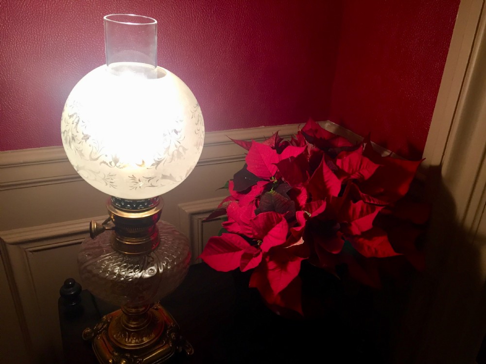 An Art Nouveau table lamp featuring an ornate cast brass base, a clear patterned glass reservoir, and a frosted spherical glass shade. View III