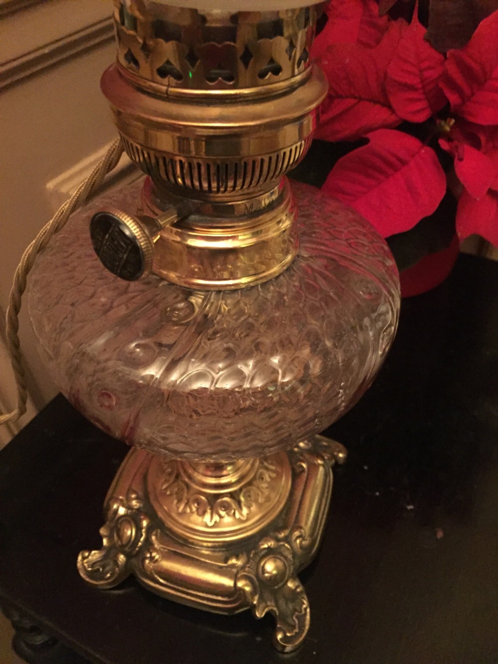 An Art Nouveau table lamp featuring an ornate cast brass base, a clear patterned glass reservoir, and a frosted spherical glass shade. View IX