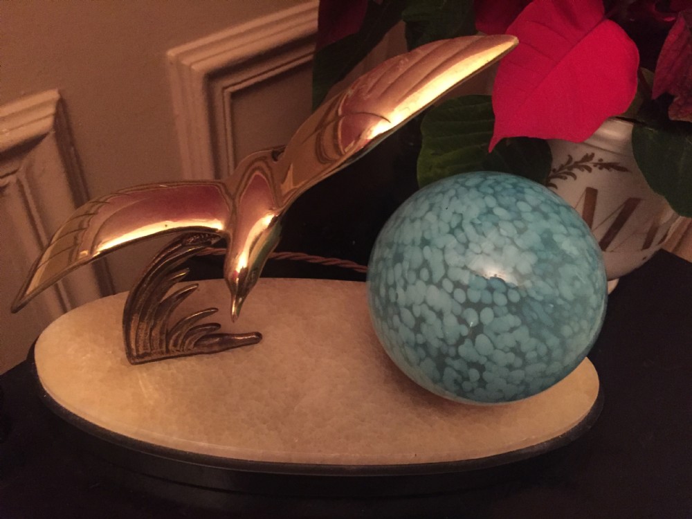 An Art Deco night light featuring a polished brass seagull sculpture and a frosted spherical glass shade mounted on an oval marble base. View VII
