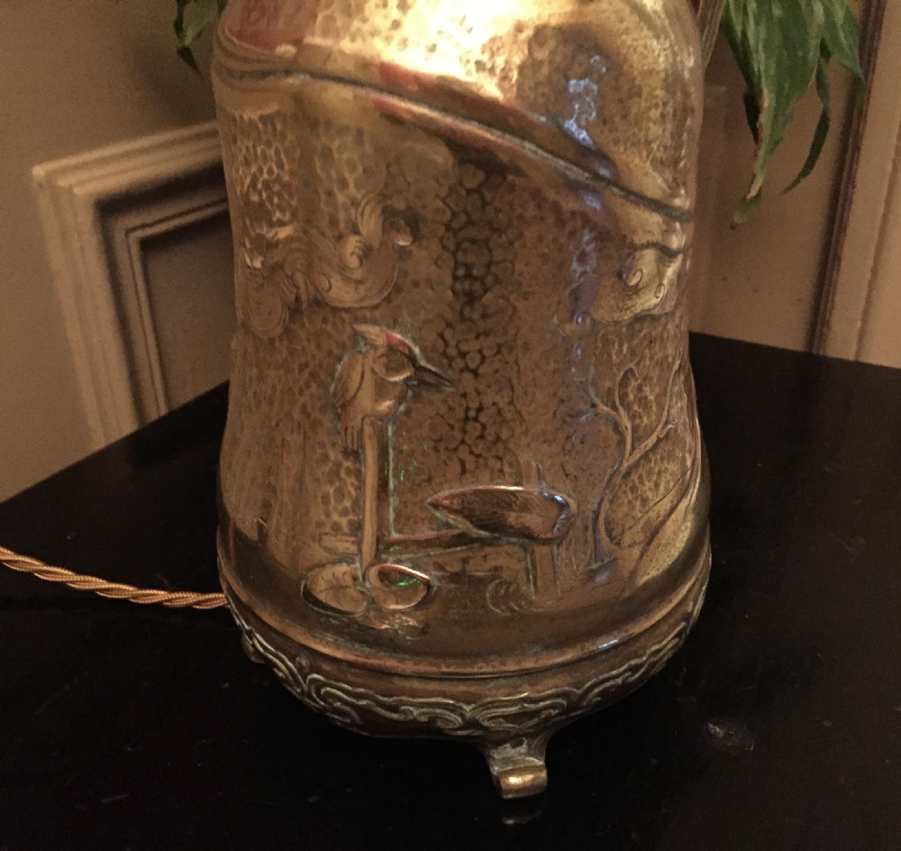 An antique bronze oil lamp featuring an embossed metal base with a side handle, a pierced gallery, and an etched glass globe shade. View V