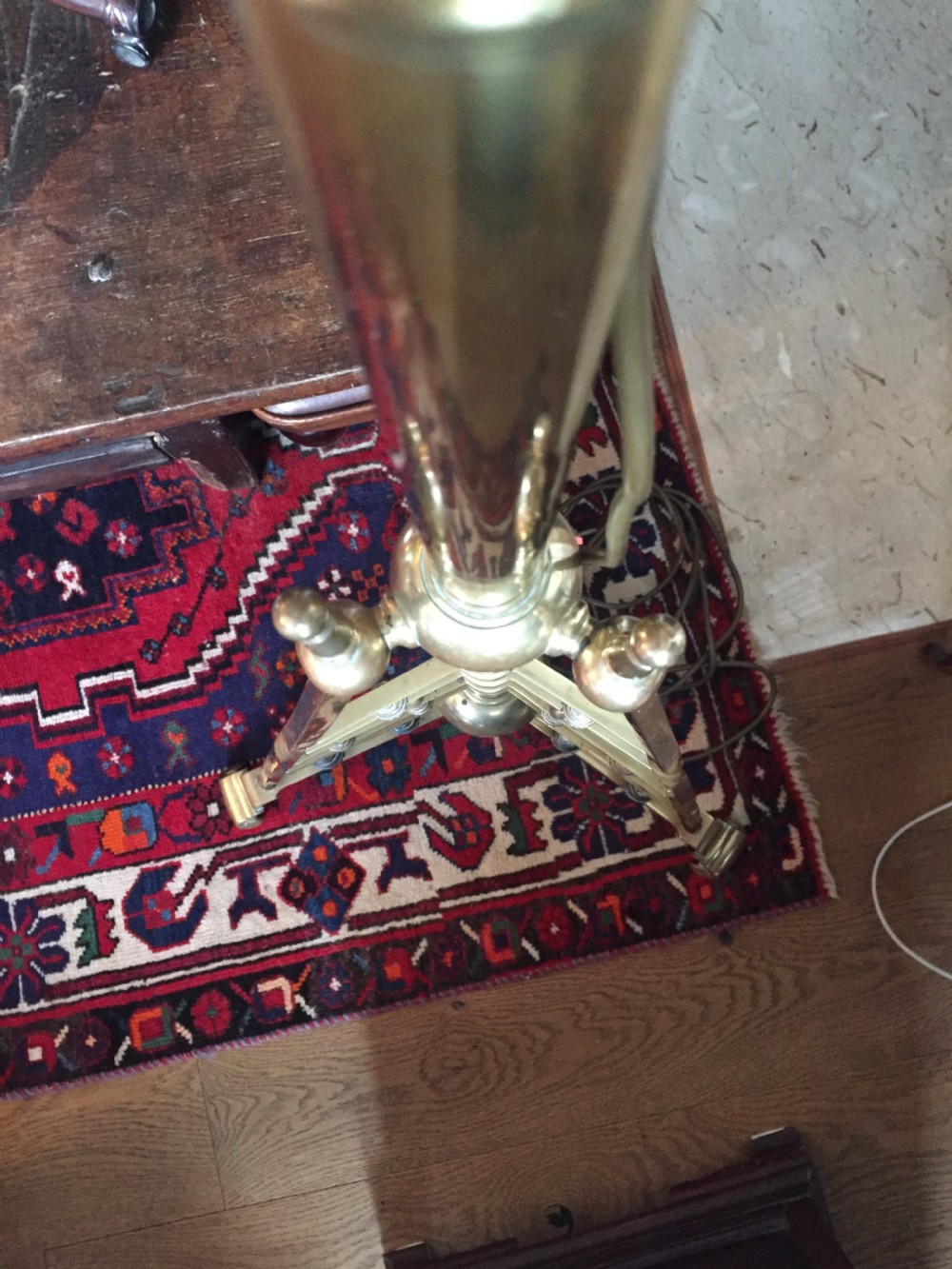 An Arts and Crafts brass standard lamp featuring a telescopic central column supported by a stepped triangular tripod base with turned finials. View XI