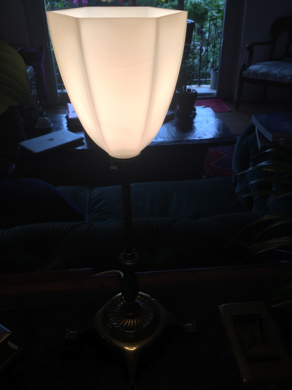 An Edwardian brass table lamp featuring a tripod base, a twisted column stem, and a faceted white opaline glass shade. View VI