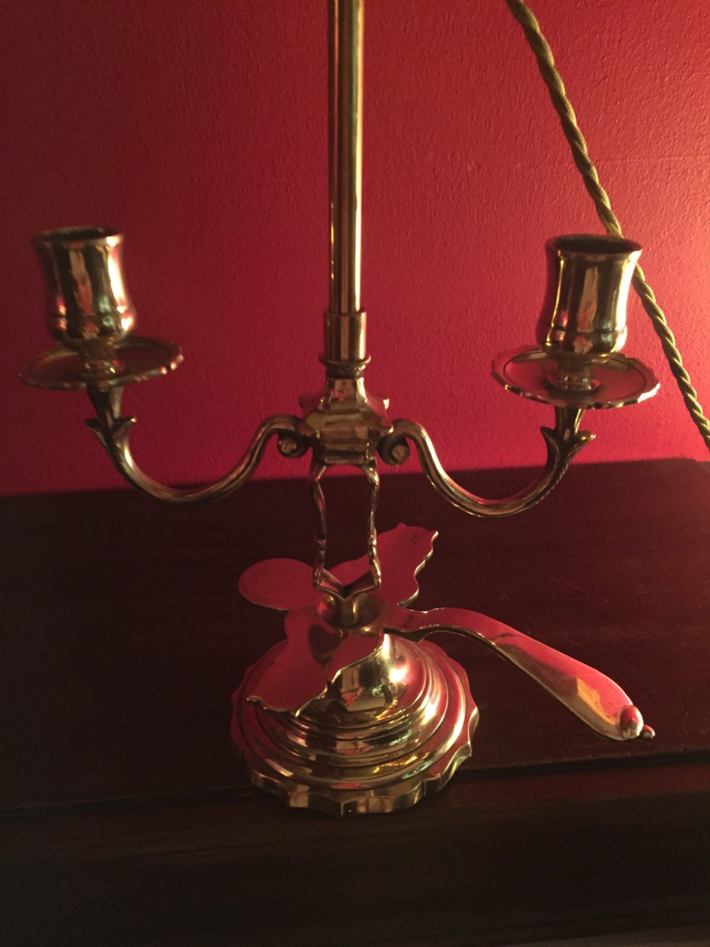 An antique French brass desk lamp with twin candlestick arms and a dark rounded lampshade. View V