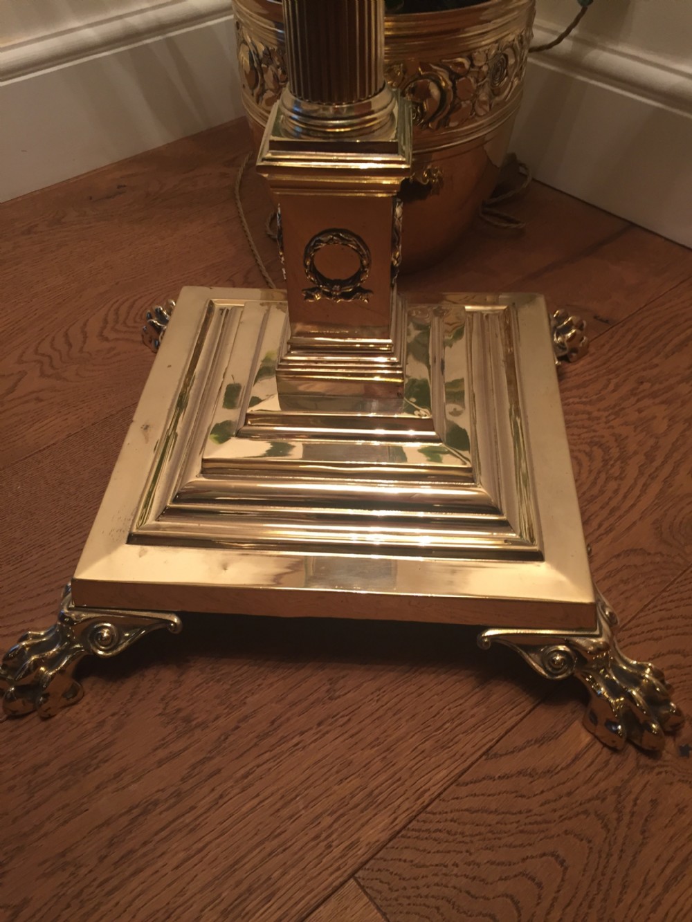 An Edwardian brass telescopic standard lamp featuring a fluted column, Corinthian capital, and a square stepped base with claw feet. View II