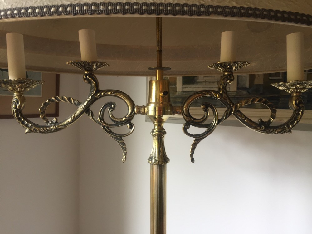 A tall Belle Epoque bronze standard lamp featuring scrollwork branches, a reeded central column, a tripod base, and an oval fabric shade. View VI