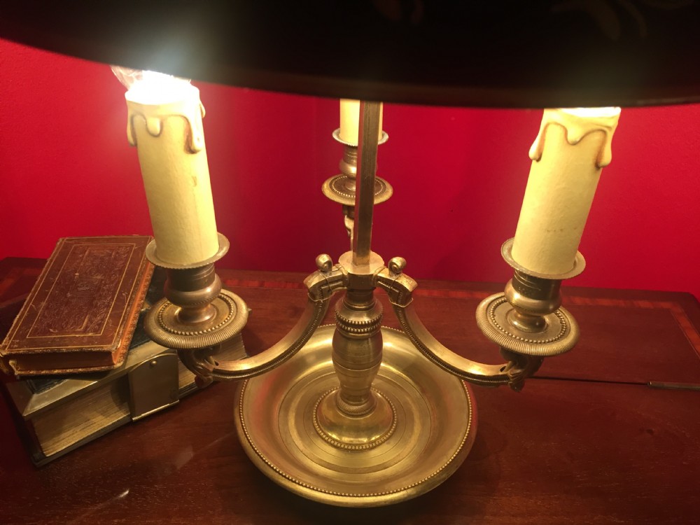 A traditional bronze bouillotte desk lamp featuring candle-style lights, a dish base, and an adjustable dark green painted tole shade with gold leaf accents. View VI