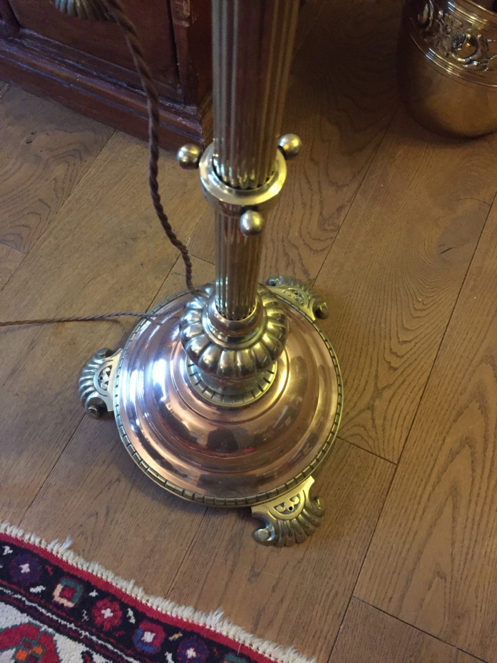 A Victorian telescopic standard lamp with a fluted brass column, height adjustment collar, and a polished copper domed base supported by cast metal feet. View IX