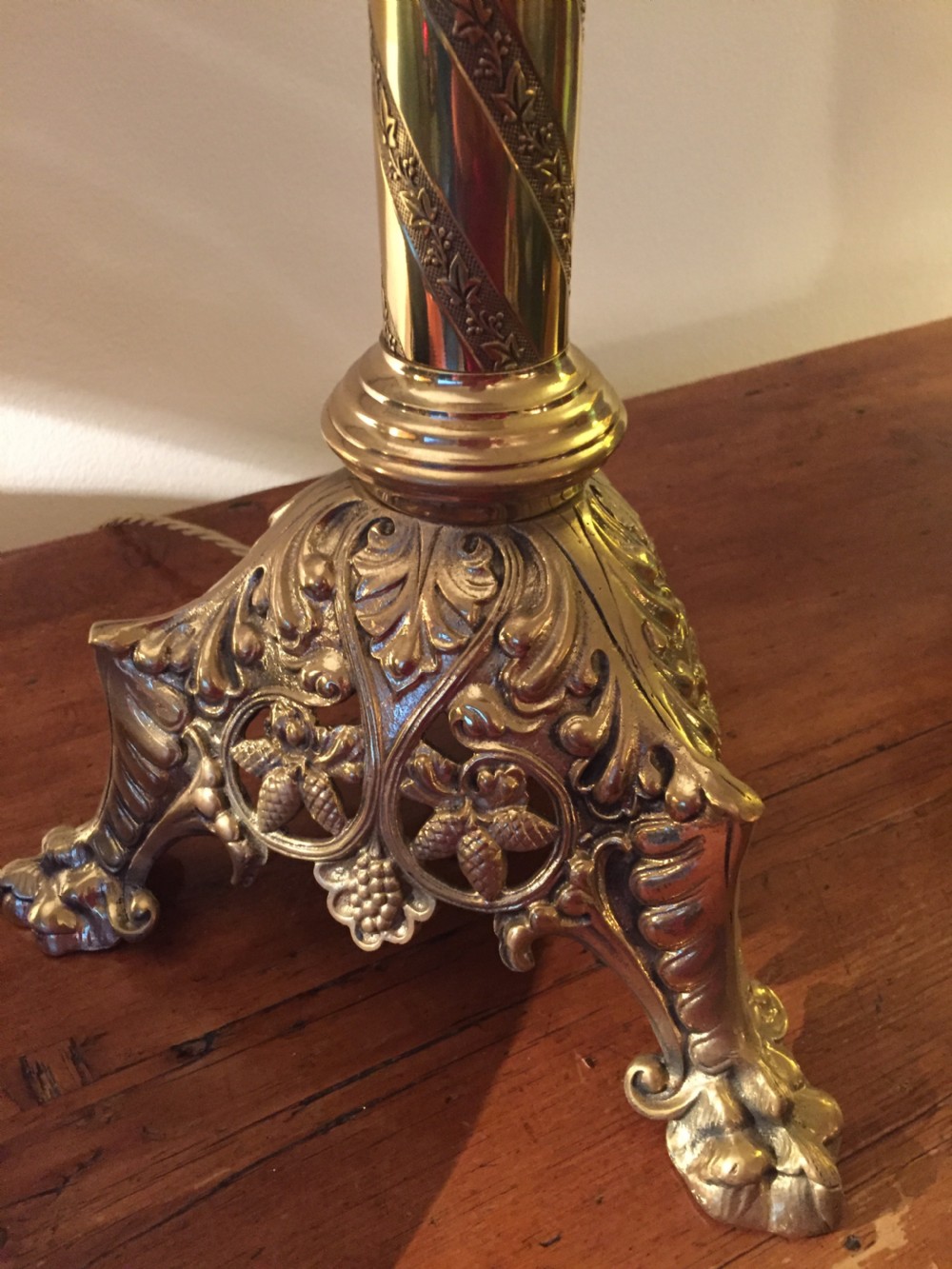 A 19th-century French brass altar candlestick converted into a table lamp, featuring an ornate tri-form base and a spiral-fluted column. View X