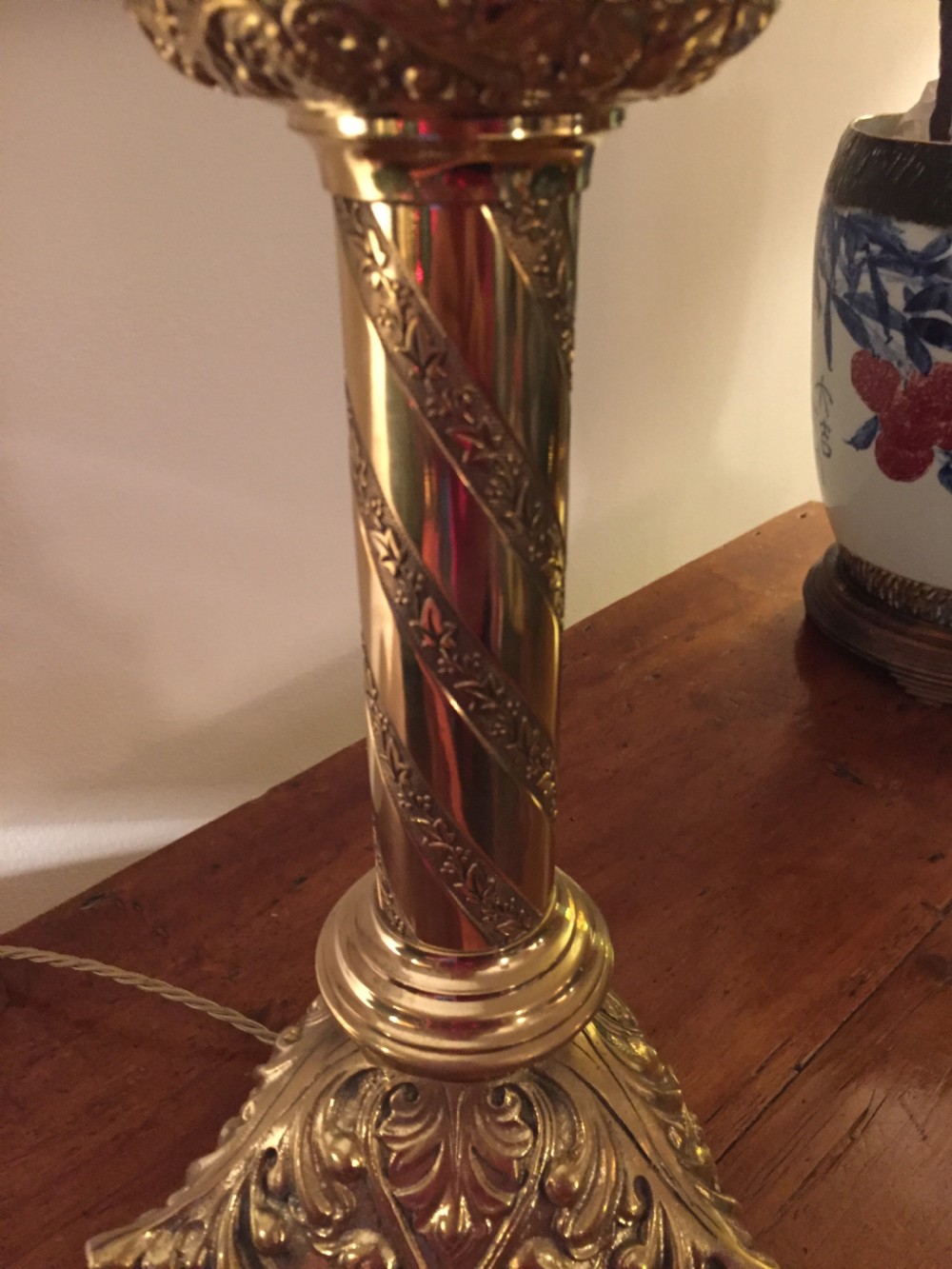 A 19th-century French brass altar candlestick converted into a table lamp, featuring an ornate tri-form base and a spiral-fluted column. View III