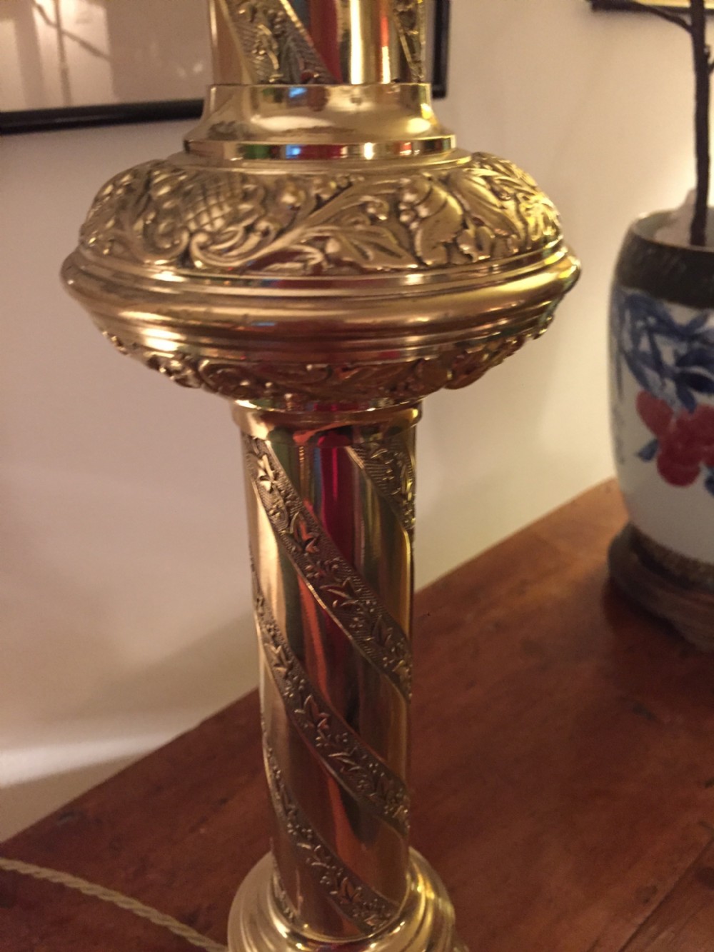 A 19th-century French brass altar candlestick converted into a table lamp, featuring an ornate tri-form base and a spiral-fluted column. View IV