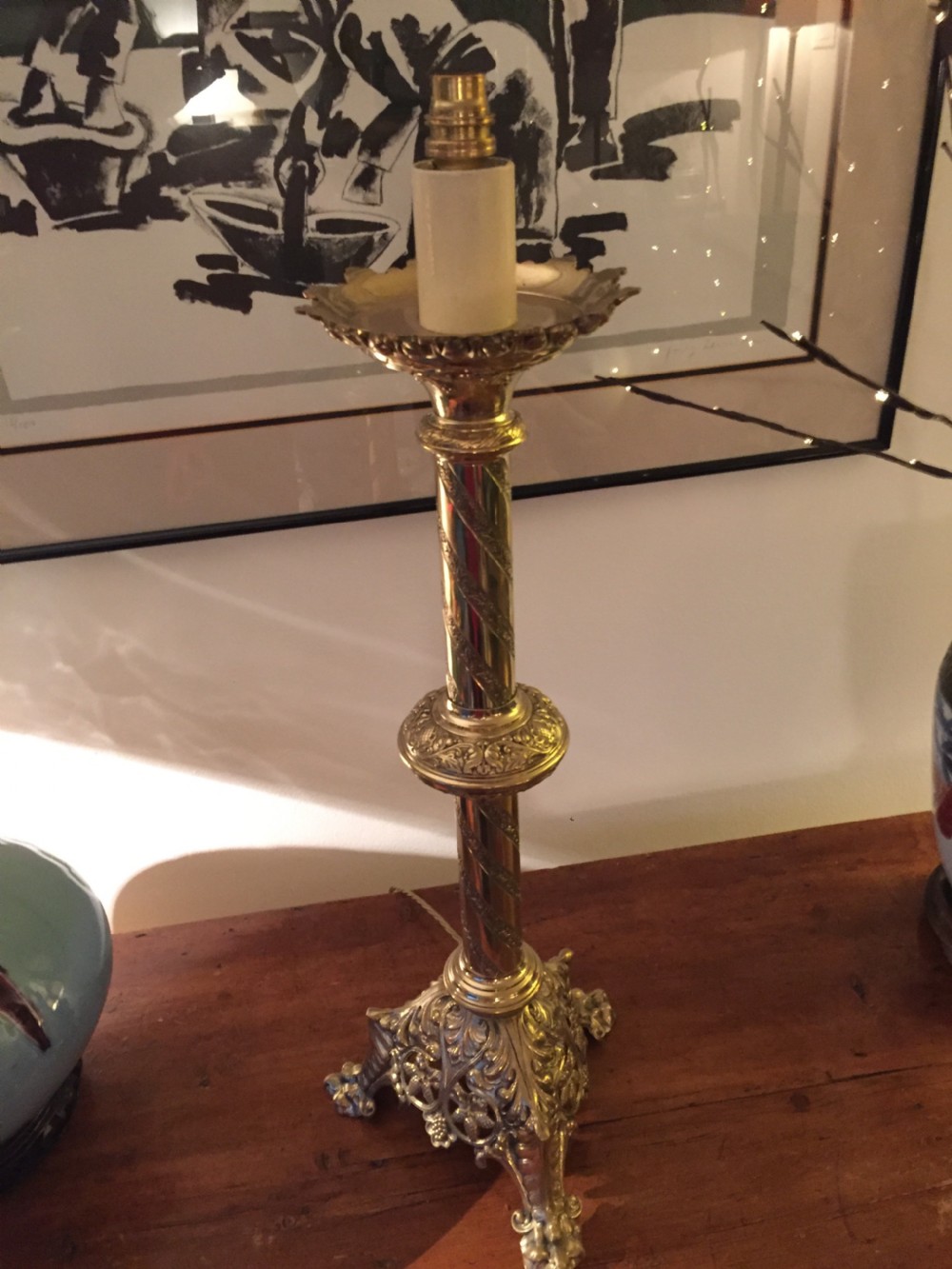 A 19th-century French brass altar candlestick converted into a table lamp, featuring an ornate tri-form base and a spiral-fluted column. View IX