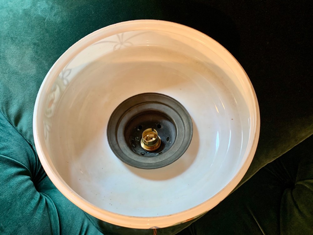 A white glass ceiling pendant shade with a brass top gallery, decorated with hand-painted blue ribbons and a central medallion depicting a cottage. View V