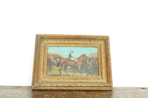 fig 7. An early 20th-century impressionistic oil painting of a mounted jockey on a bay racehorse in a paddock, framed in a carved gilded wooden frame.