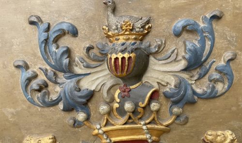 fig 4. A framed 19th-century Dutch heraldic marriage plaque depicting two carved gilt lion supporters holding alliance coats of arms under a helmet crest and motto banner.