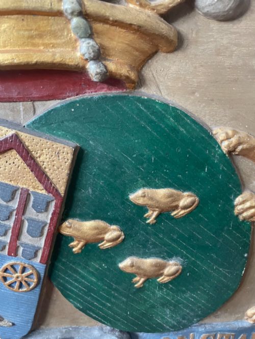 fig 6. A framed 19th-century Dutch heraldic marriage plaque depicting two carved gilt lion supporters holding alliance coats of arms under a helmet crest and motto banner.