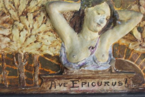 fig 6. A rectangular Arts and Crafts polychrome plaster relief featuring a central classical figure framed by trees and inscribed Ave Epicurus within a gilt frame.